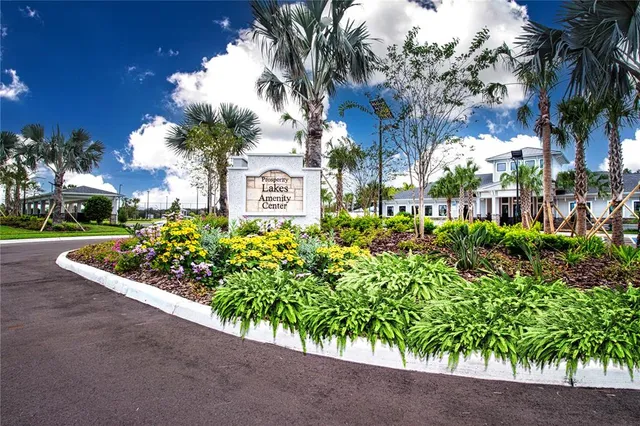 a kitchen with a table chairs sink and cabinets