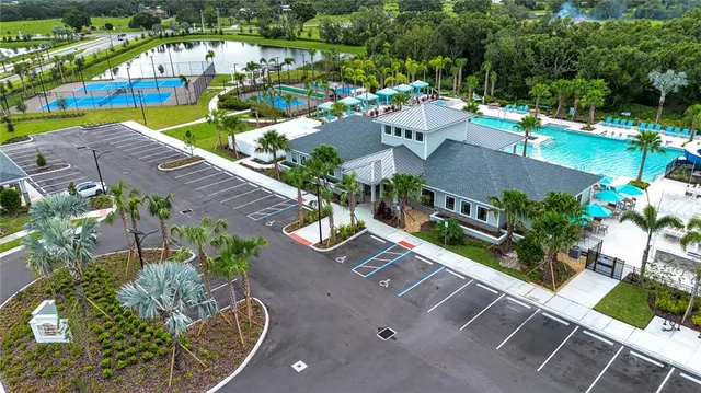 a living room with furniture a fireplace and a chandelier