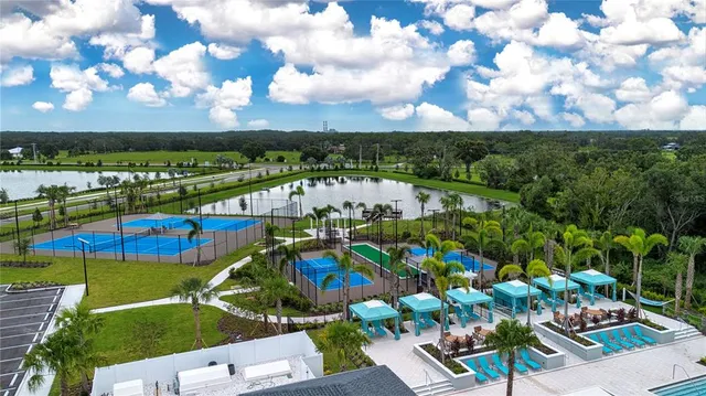 a view of a dining hall with lots of furniture and a large window