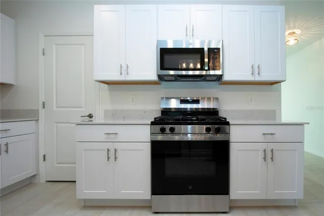 a view of a refrigerator in kitchen and window