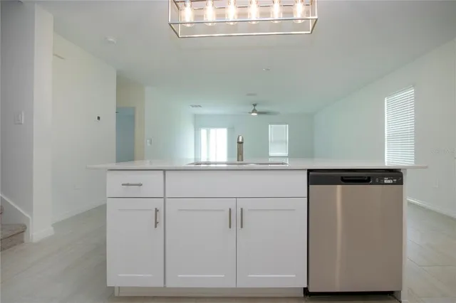 a view of a kitchen with a dishwasher cabinets and wooden floor