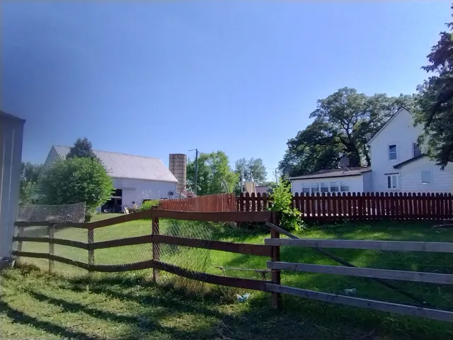a view of a bench in front of a house