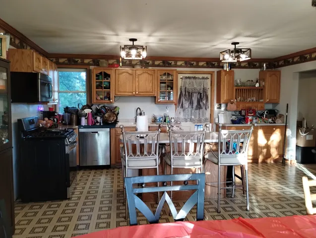 a view of a dining room with furniture and chandelier