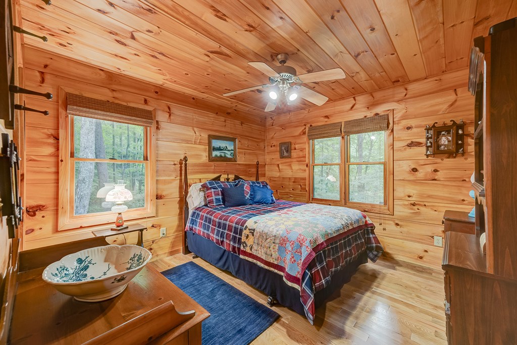 584 Laurel Ridge Drive Blue Ridge, GA 30513 - Photo 18 of 49 a bedroom with a bed and a large window with the garden view