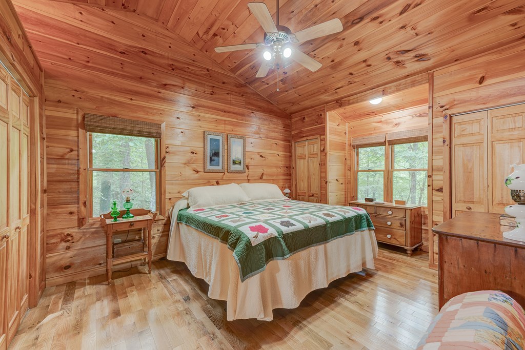 584 Laurel Ridge Drive Blue Ridge, GA 30513 - Photo 24 of 49 a bedroom with a bed and large windows