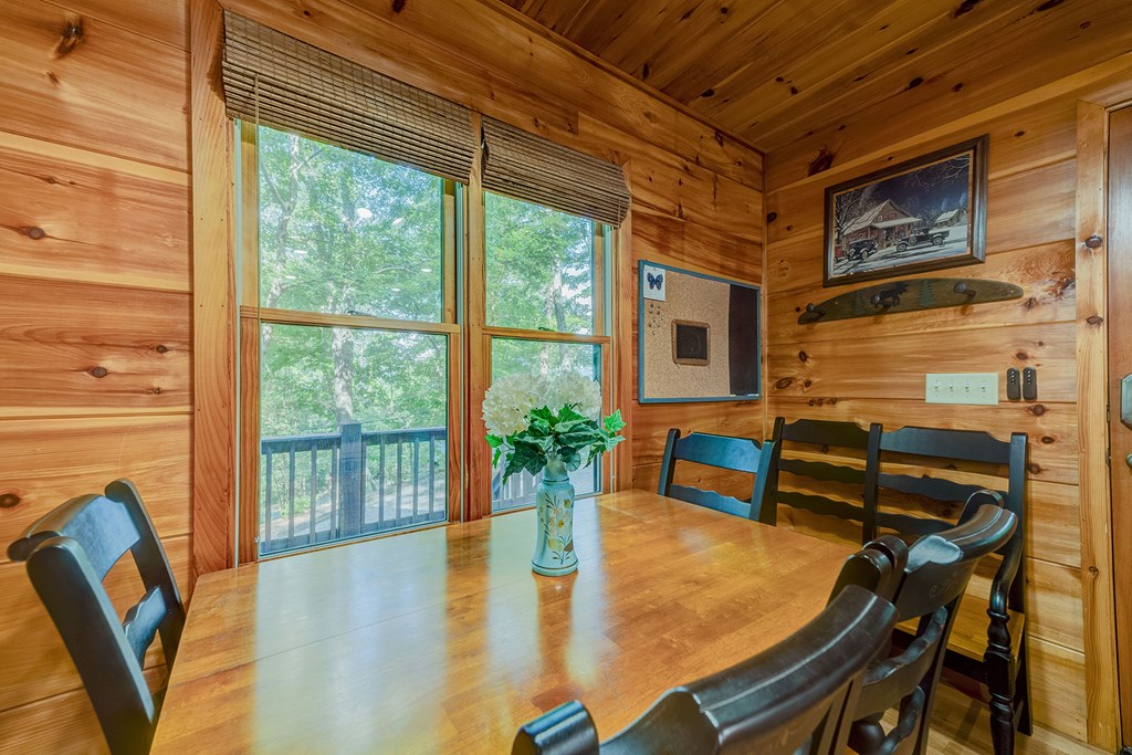584 Laurel Ridge Drive Blue Ridge, GA 30513 - Photo 8 of 49 a dining room with furniture and a floor to ceiling window