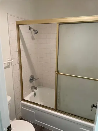 a bathroom with a shower and toilet