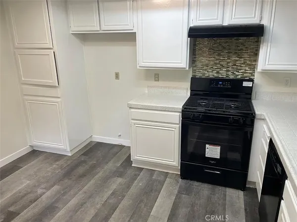 a kitchen with a stove and a cabinet