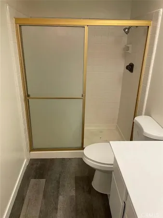 a bathroom with a sink a toilet a shower a vanity and a shower