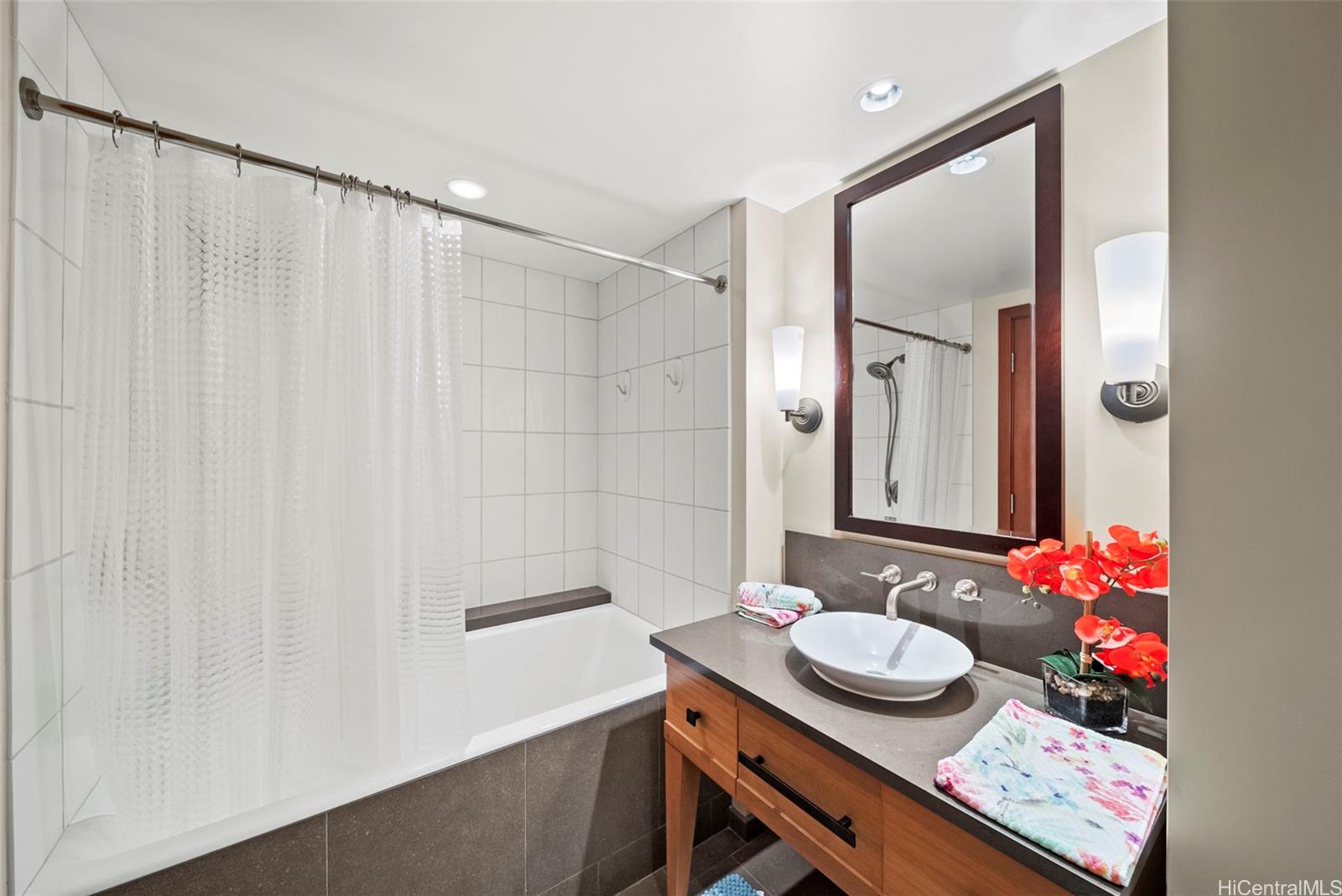 92-104 Waialii Place, Unit OPH 1401 Kapolei, HI 96707 - Photo 13 of 24 a bathroom with a sink a vanity and a mirror