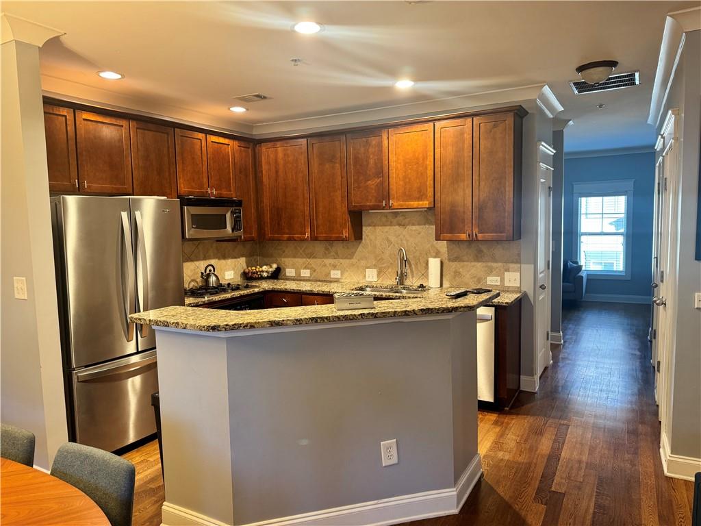 655 Mead Street Southeast, Unit 28 Atlanta, GA 30312 - Photo 23 of 42 a kitchen with stainless steel appliances granite countertop a refrigerator a sink dishwasher a stove and a refrigerator