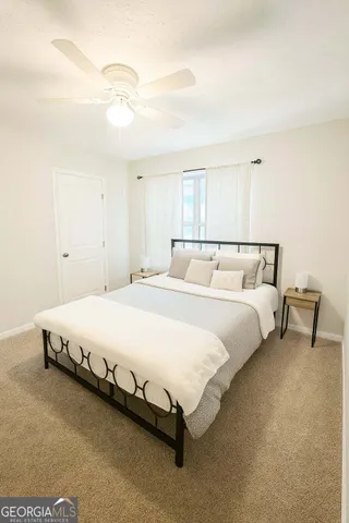 a bedroom with a bed and a night stand