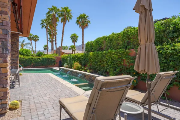 a view of a chair and tables in the patio with a fire pit
