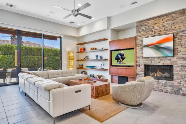 a living room with furniture fireplace and flat screen tv
