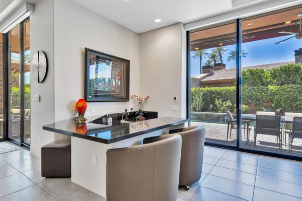 a dining room with furniture and a mirror