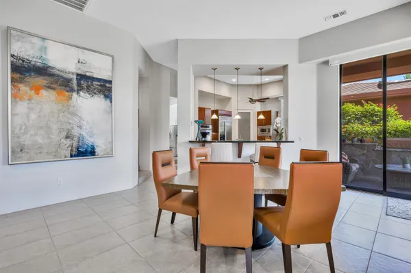 a dining room with furniture and a window