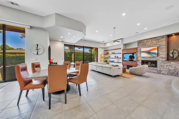 a living room with furniture and a dining table