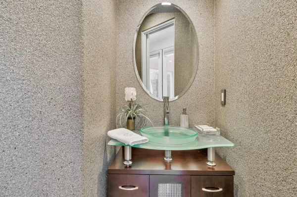 wooden floor with a mirror and a sink