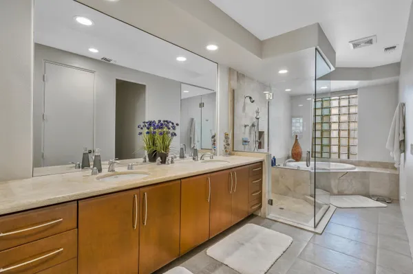 a bathroom with a double vanity sink mirror and double