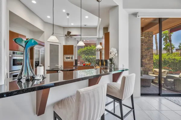 a large kitchen with a table and chairs