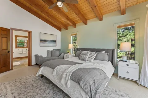 a spacious bedroom with a large bed and a window