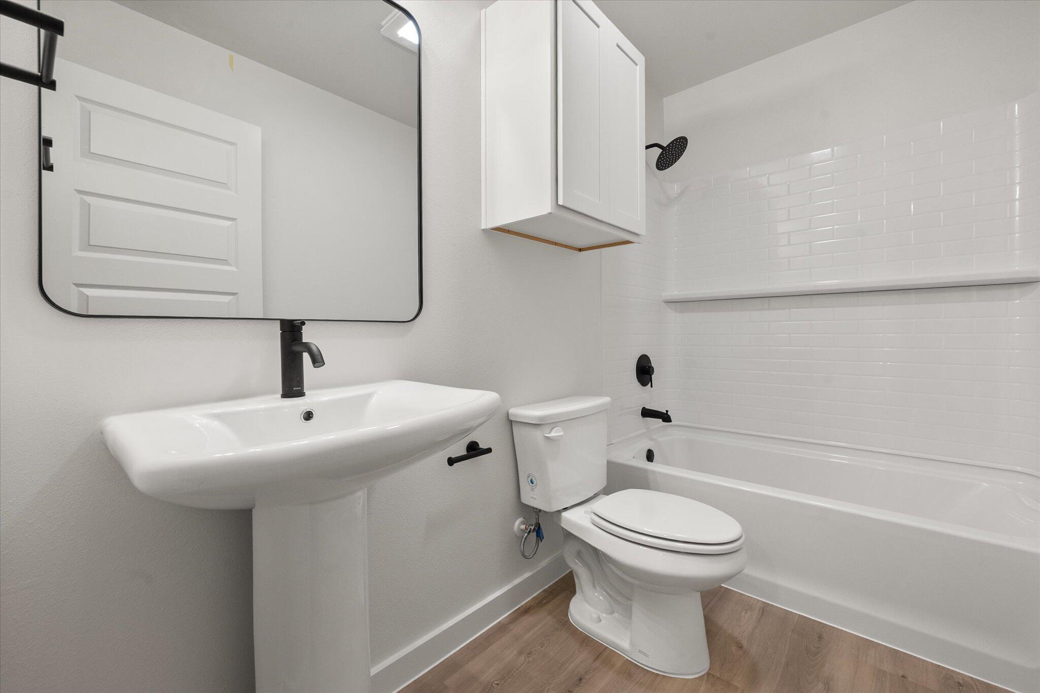 6308 Volney Avenue Lubbock, TX 79407 - Photo 16 of 19 a bathroom with a toilet a sink and mirror