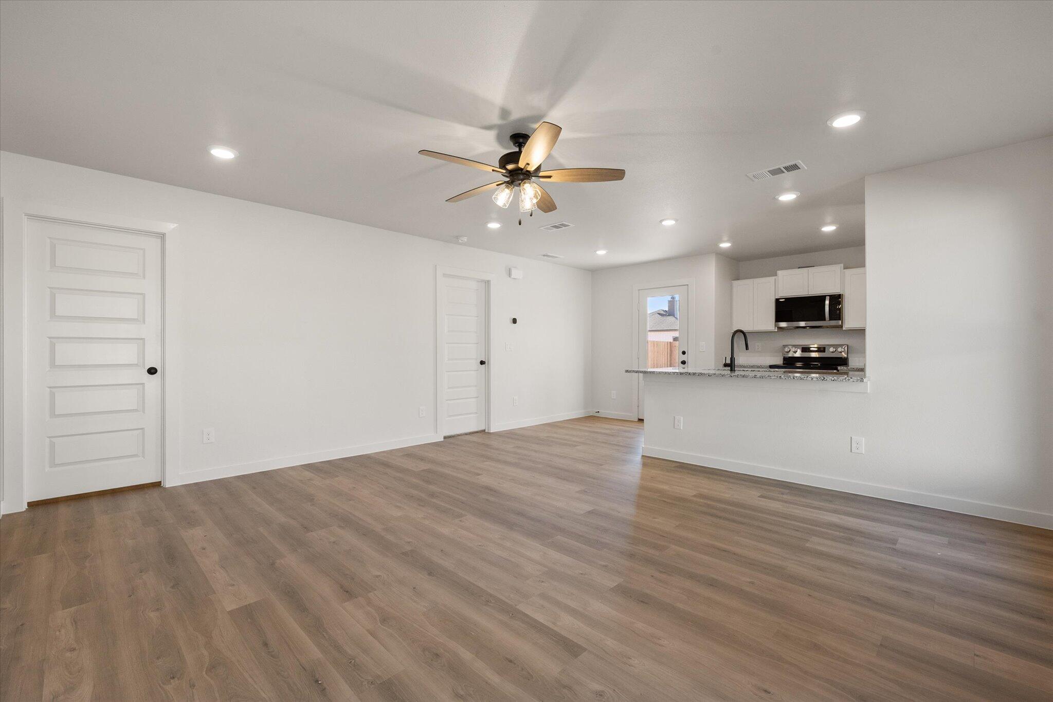 6308 Volney Avenue Lubbock, TX 79407 - Photo 4 of 19 a view of a kitchen with a sink and a ceiling fan
