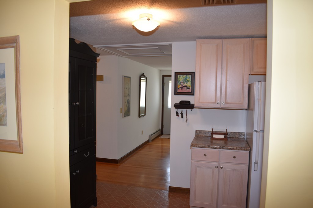 87 Logtown Road Amherst, MA 01002 - Photo 11 of 30 a kitchen with cabinets and a wooden floor