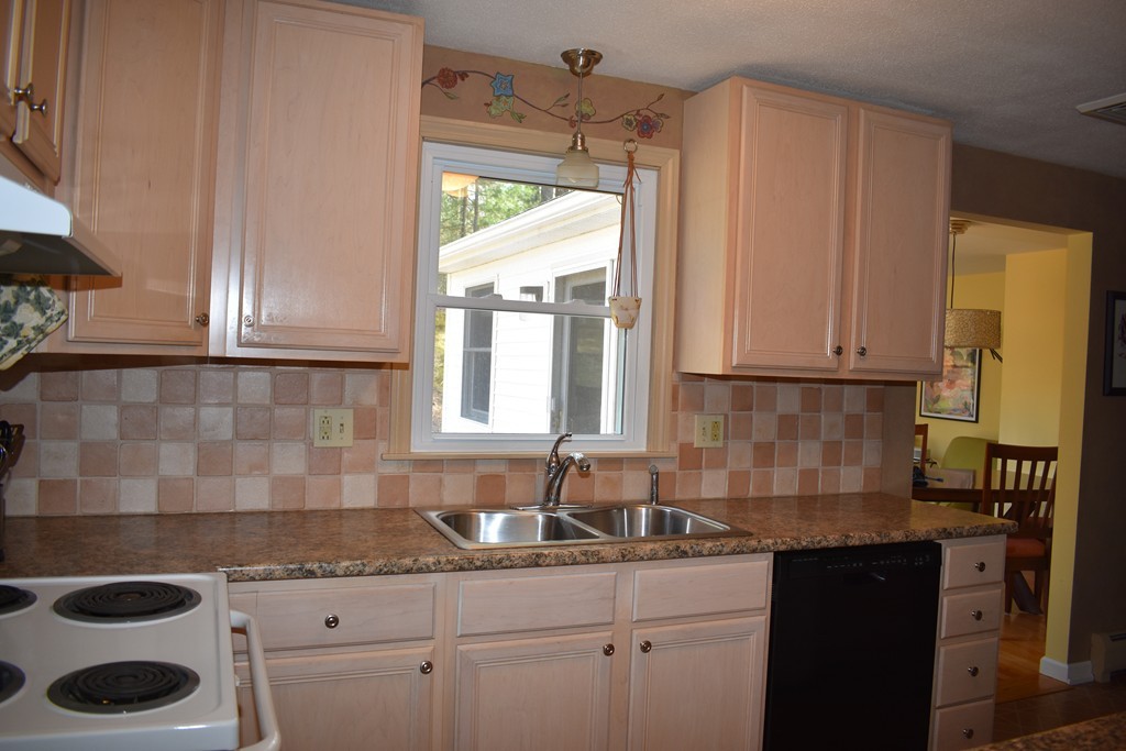 87 Logtown Road Amherst, MA 01002 - Photo 13 of 30 a kitchen with granite countertop a sink a stove and a window