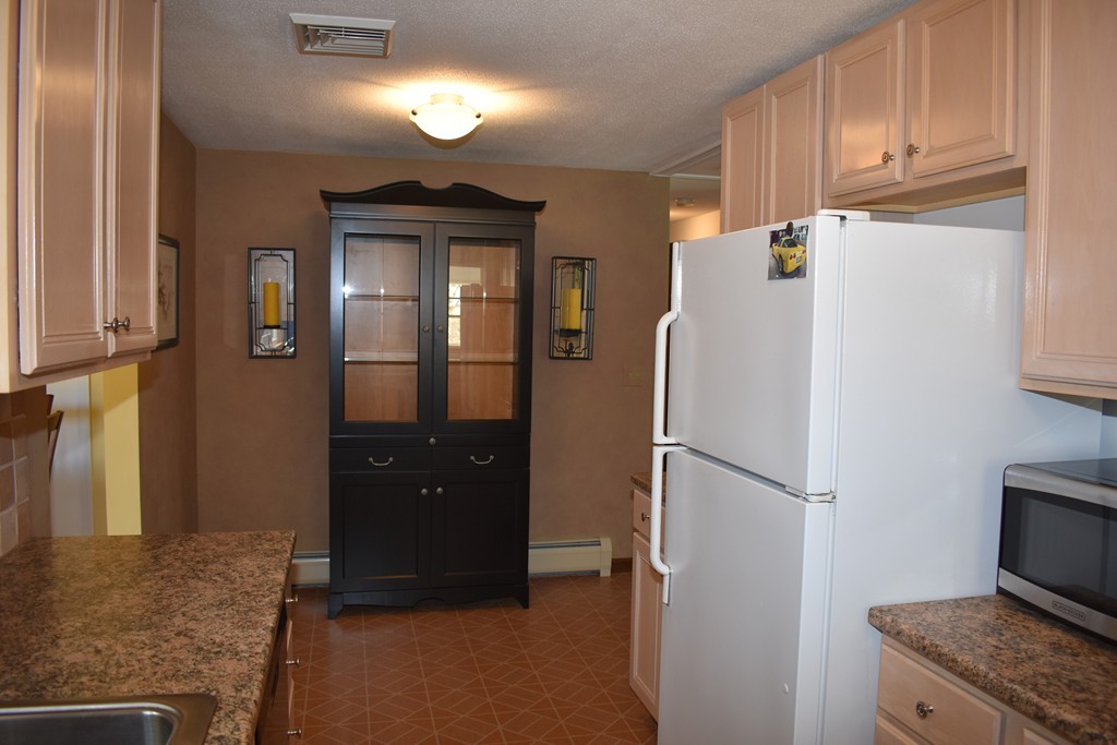 87 Logtown Road Amherst, MA 01002 - Photo 14 of 30 a kitchen with a refrigerator and cabinets
