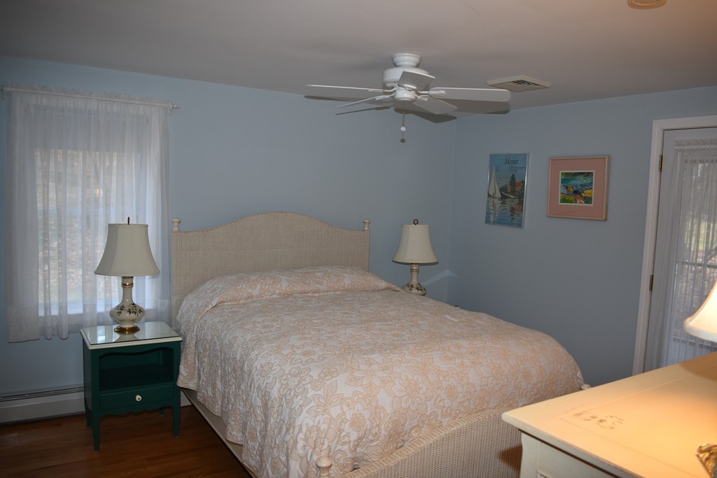 87 Logtown Road Amherst, MA 01002 - Photo 22 of 30 a bedroom with a bed and a lamp on table