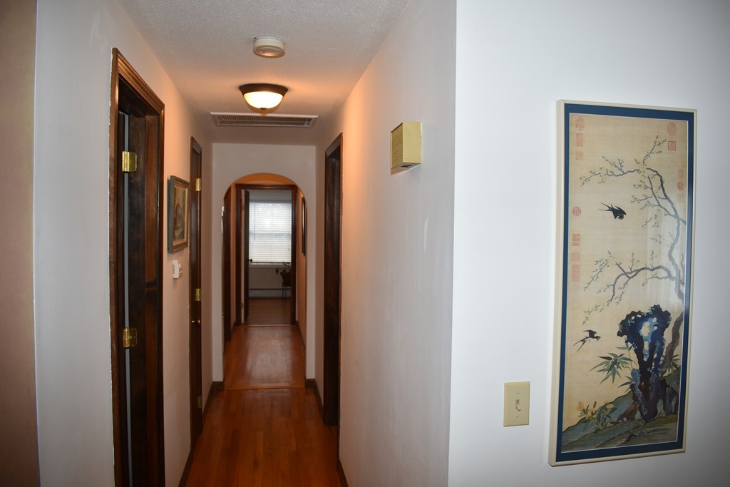 87 Logtown Road Amherst, MA 01002 - Photo 28 of 30 a view of a hallway with wooden floor and a living room