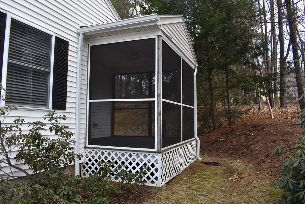 87 Logtown Road Amherst, MA 01002 - Photo 6 of 30 a view of a wooden house with a large window and wooden fence