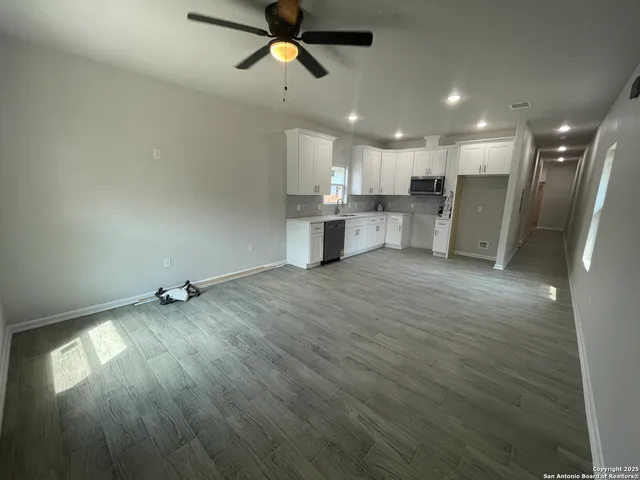 a view of a kitchen with a sink and a window
