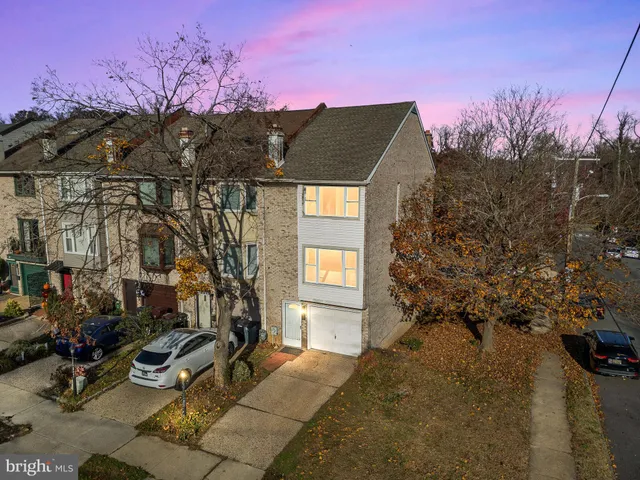 a view of a house with a yard and a tree