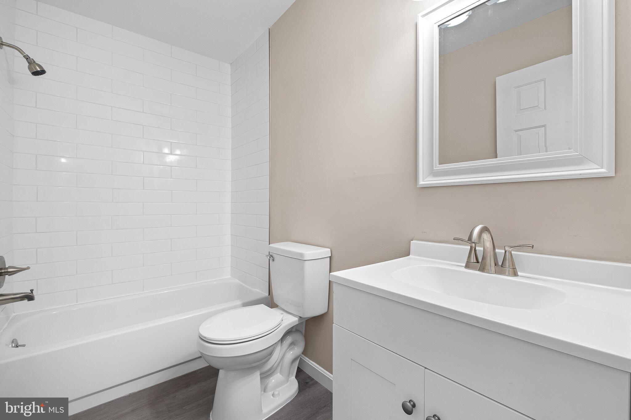 1301 Shallcross Avenue Wilmington, DE 19806 - Photo 21 of 33 a bathroom with a sink a toilet and a bathtub