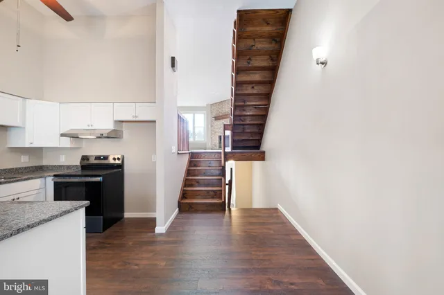 a kitchen with granite countertop a stove and a refrigerator
