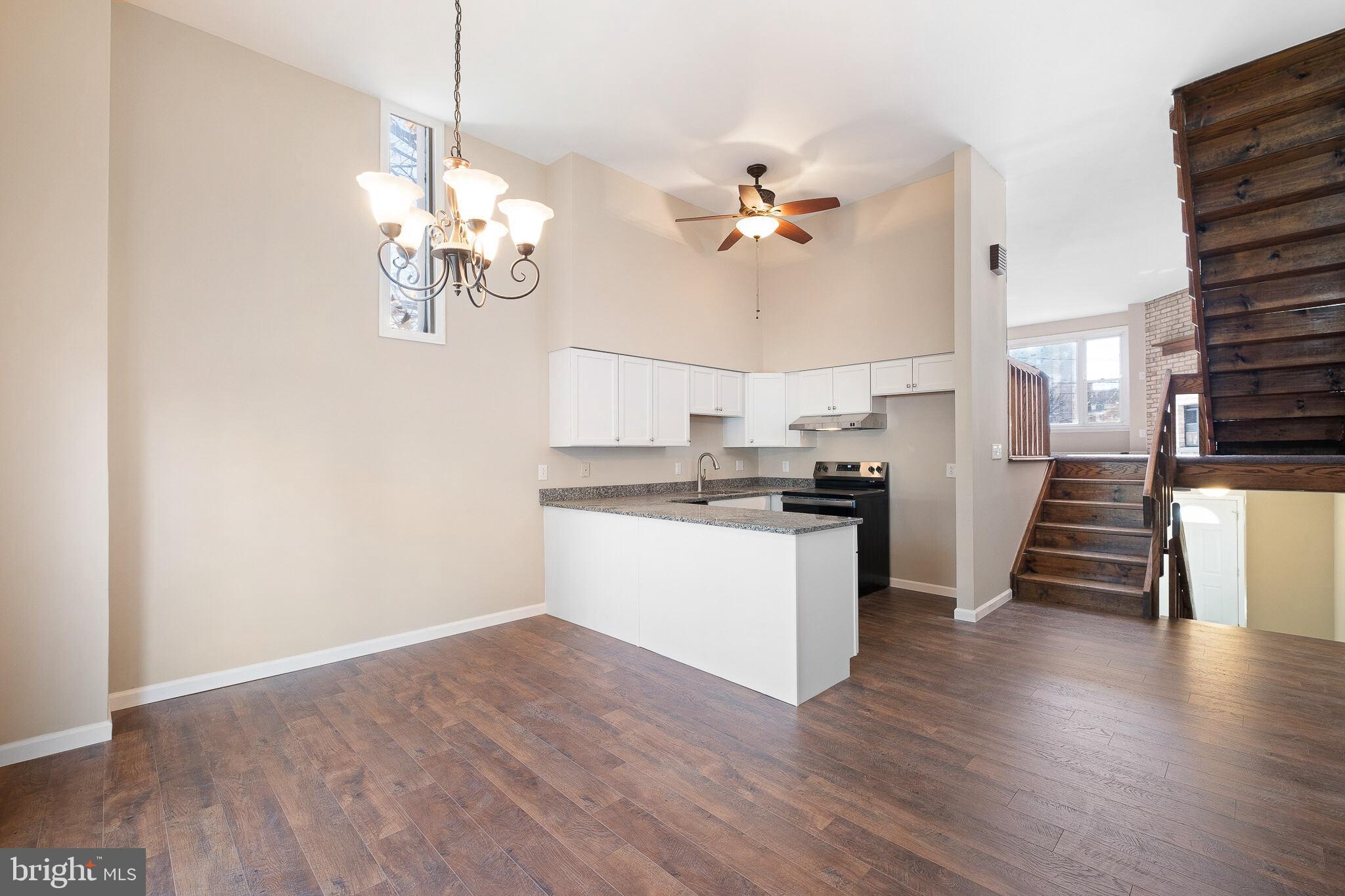 1301 Shallcross Avenue Wilmington, DE 19806 - Photo 8 of 33 a view of a kitchen with a sink a ceiling fan and wooden floor