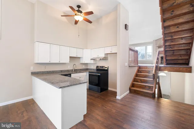 a kitchen with stainless steel appliances a stove a sink and a refrigerator