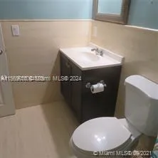 a bathroom with a toilet and shower