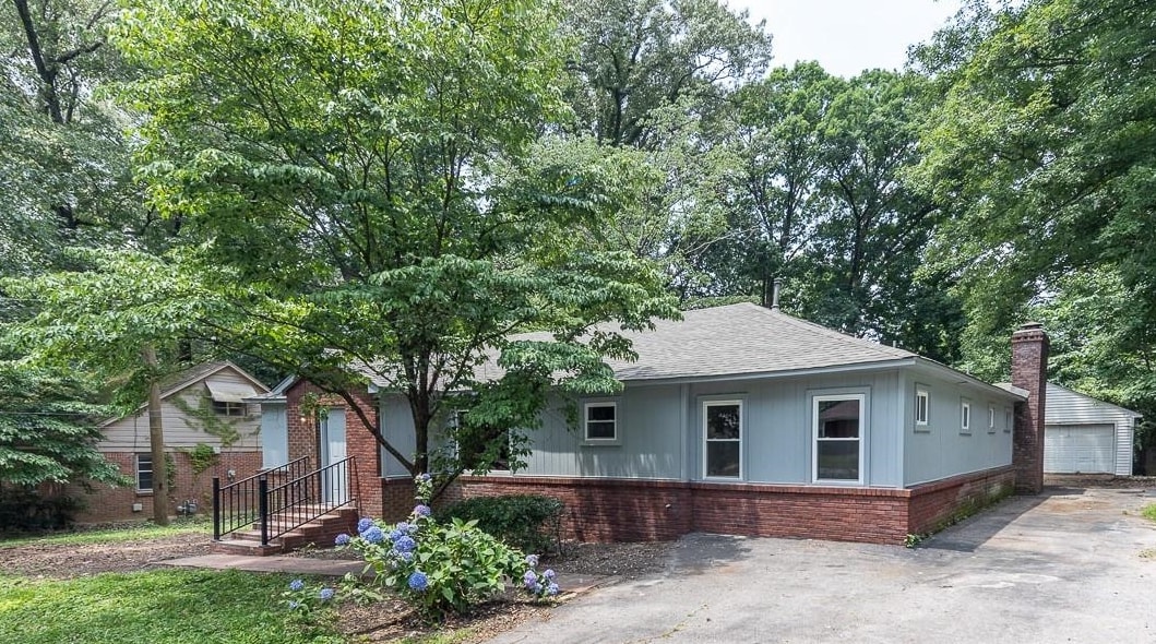 1461 Phillips Road Memphis, TN 38134 - Photo 1 of 19 a front view of a house with garden