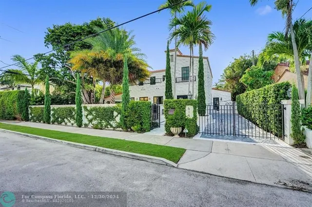 an aerial view of a house with garden space and street view