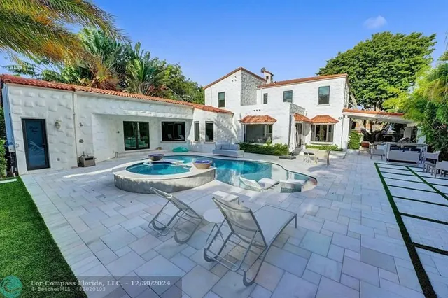 a view of a patio with a table chairs and a backyard