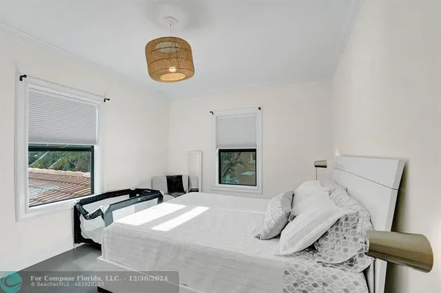 a view of backyard with seating space and trees in the background