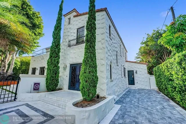 a en suite spacious bedroom with a large window and a flat tv screen