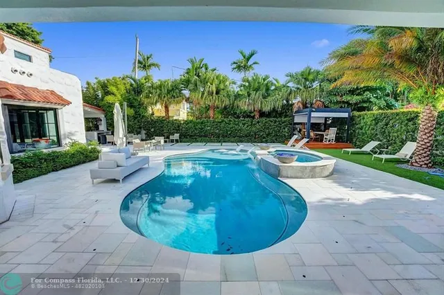 a kitchen with white cabinets and sink