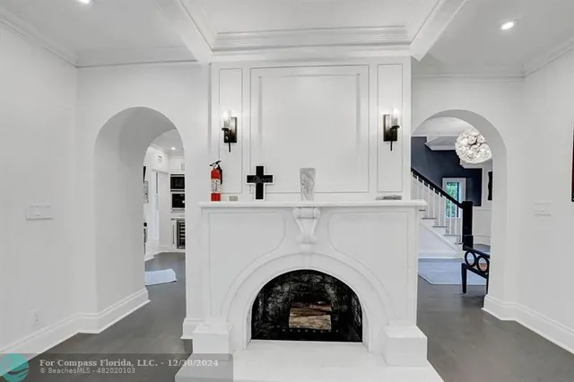 a view of a hallway with entryway and chandelier