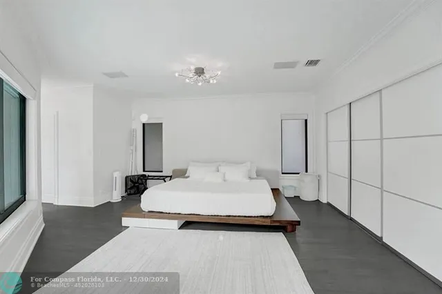 a bedroom with two beds and a window