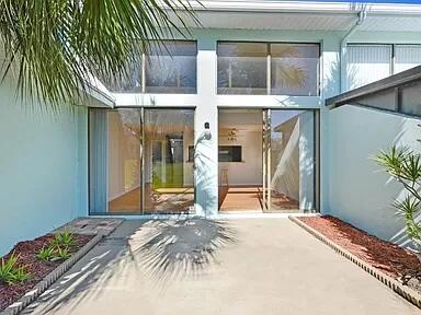 2 Country Club Road, Unit 26 Cocoa Beach, FL 32931 - Photo 2 of 10 a bed room with a bed and a window