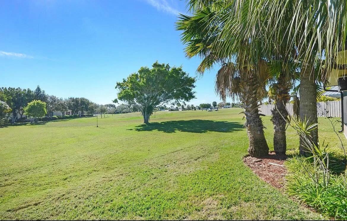 2 Country Club Road, Unit 26 Cocoa Beach, FL 32931 - Photo 4 of 10 a view of a lake with a yard